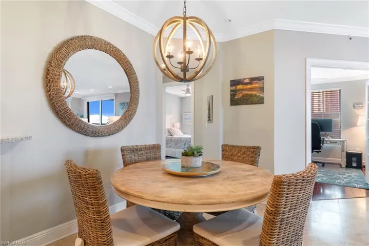 Dining room featuring a notable chandelier and crown molding