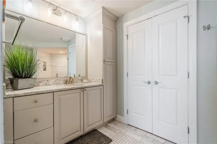 Bathroom featuring vanity and a shower with door