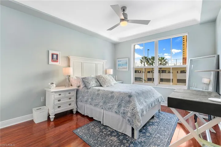 Bedroom featuring ceiling fan, dark hardwood / wood-style flooring, and crown molding