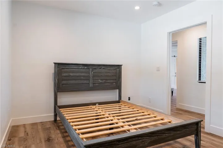 Unfurnished bedroom with recessed lighting, wood finished floors, and baseboards