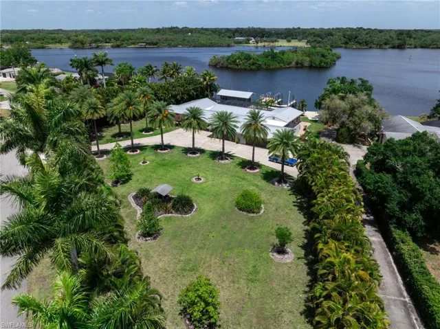 Birds eye view of property with a water view