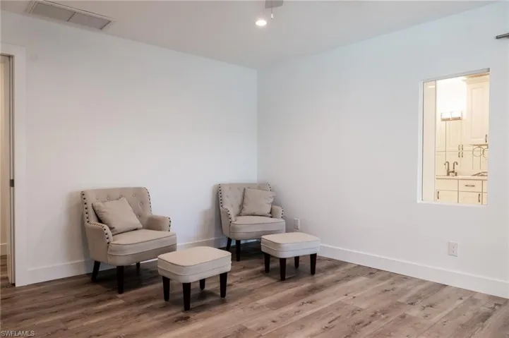 Sitting room featuring baseboards, light wood-style floors, and visible vents