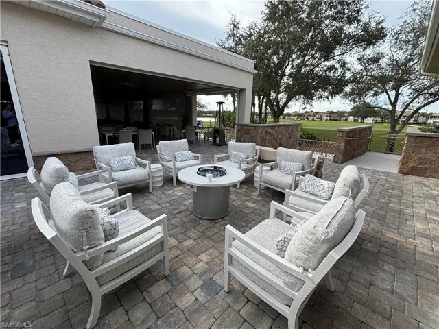 View of patio with an outdoor living space with a fire pit