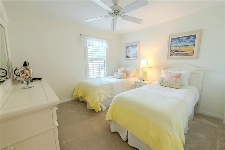 Bedroom with light colored carpet and ceiling fan