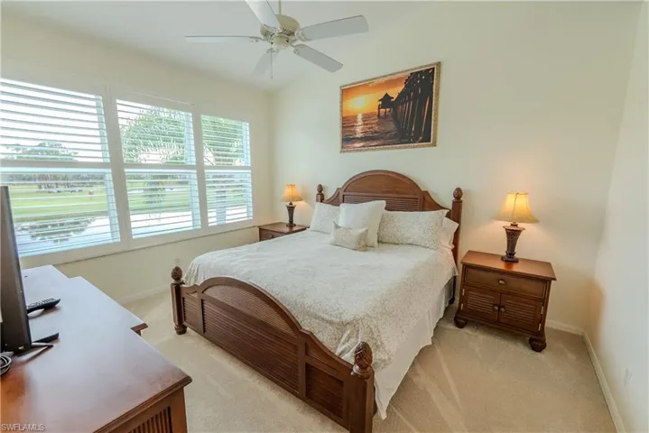 Bedroom with light colored carpet and ceiling fan