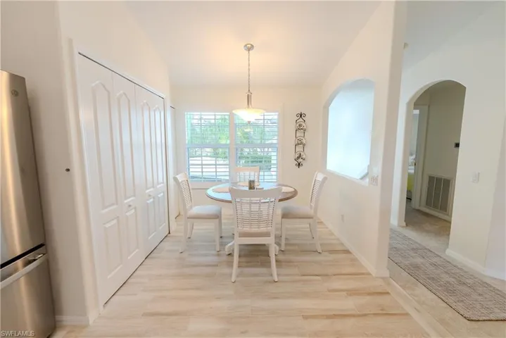 Kitchen featuring ceiling fan, stainless steel appliances, white cabinets, sink, and backsplash