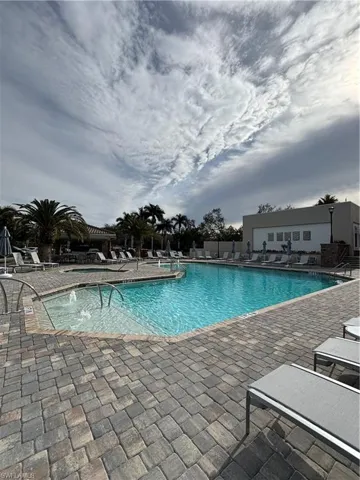 View of pool with a patio and pool water feature