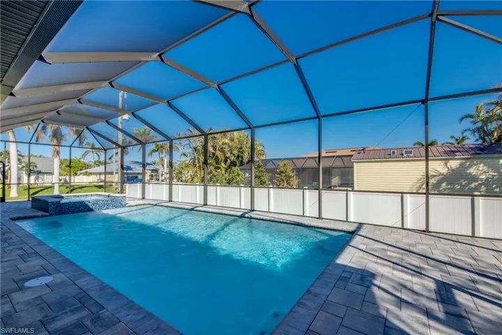 View of pool with a lanai, an in ground hot tub, and a patio