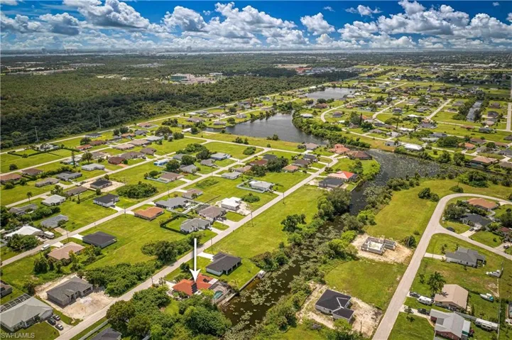 Aerial perspective of suburban area with a large body of water