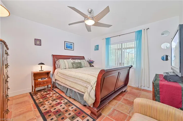 Bedroom with baseboards and ceiling fan