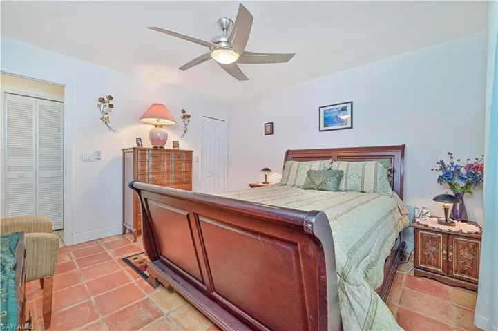 Bedroom with a ceiling fan and light tile patterned floors