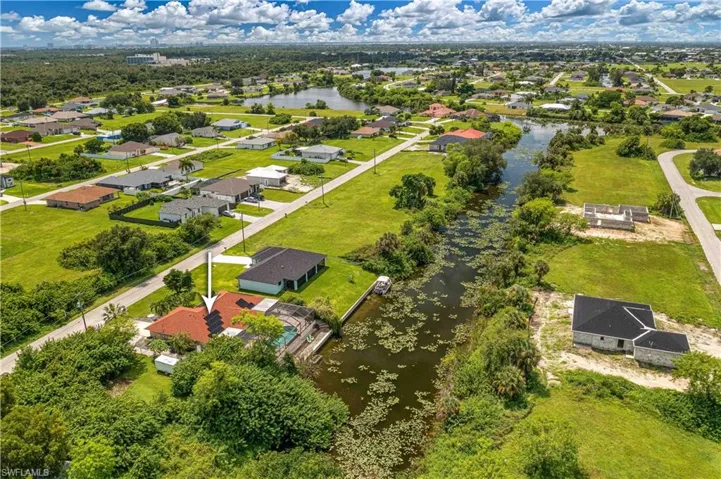Aerial perspective of suburban area featuring a large body of water