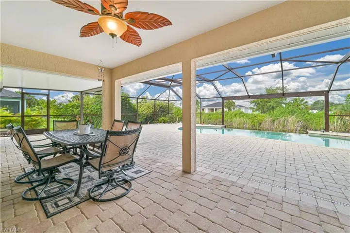 Sunroom / solarium featuring a pool and ceiling fan