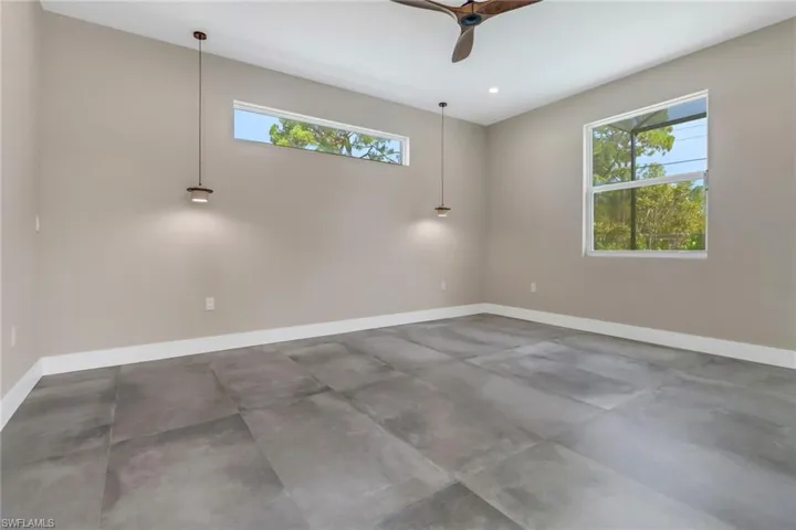 Empty room featuring ceiling fan, concrete flooring, and recessed lighting