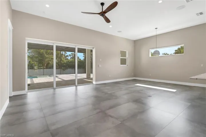 Unfurnished room featuring healthy amount of natural light, a ceiling fan, and recessed lighting