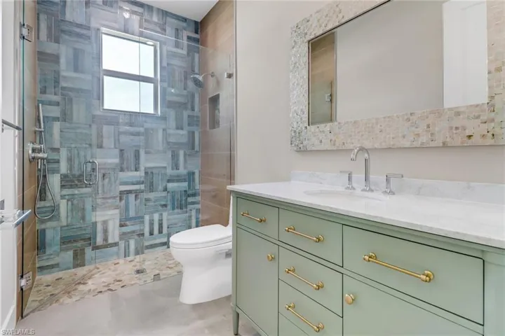 Full bathroom with vanity and a stall shower