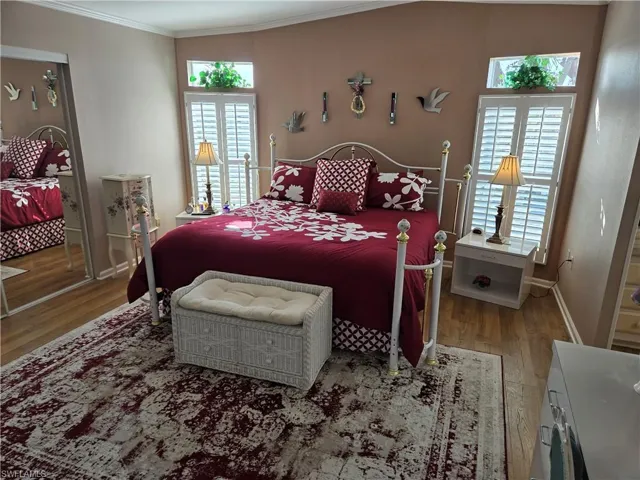 Bedroom featuring wood-type flooring and ornamental molding