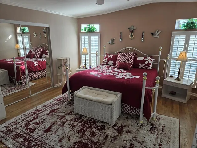 Bedroom with crown molding and wood-type flooring