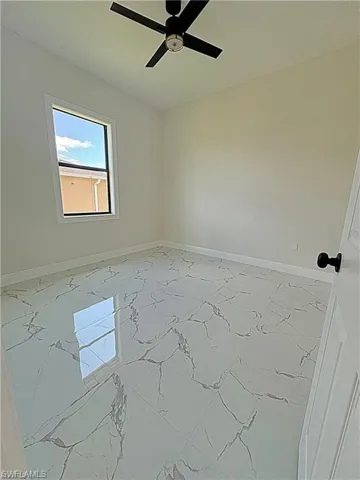 Empty room with light marble finish floors and baseboards