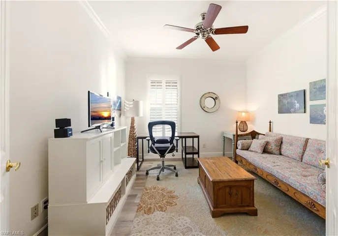 Office with crown molding, Luxury Vinyl flooring, and a ceiling fan