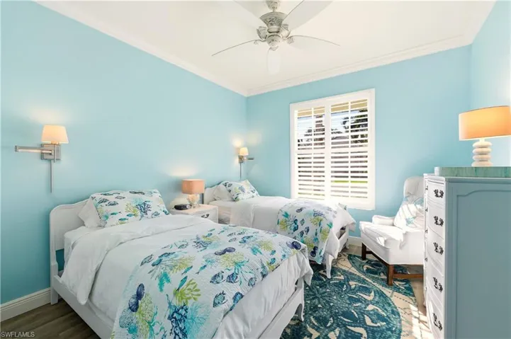 Guest Bedroom featuring crown molding, ceiling fan, and Luxury Vinyl floors