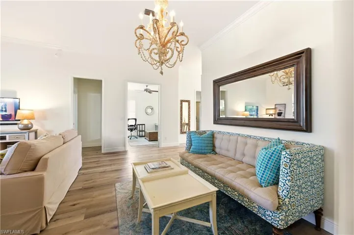 Dining Room featuring crown molding, Luxury Vinyl floors, and a chandelier