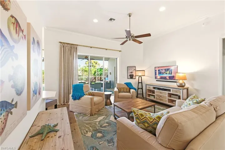 Great Room with a ceiling fan, crown molding, recessed lighting, and Luxury Vinyl floors