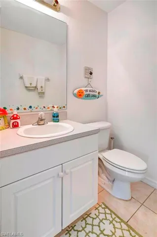 Bathroom with vanity and light tile patterned flooring
