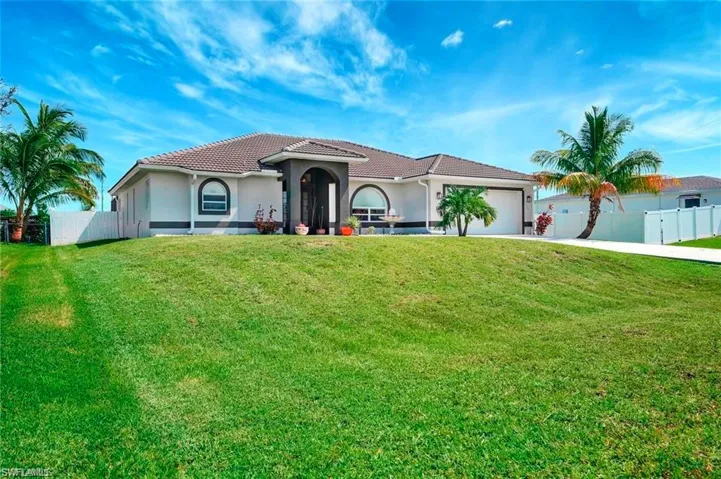 Mediterranean / spanish-style home with stucco siding, concrete driveway, a tile roof, and a garage