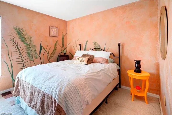 Carpeted bedroom featuring baseboards and wallpapered walls