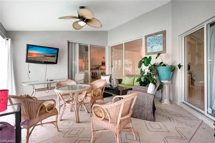 Sunroom featuring a ceiling fan, an outdoor lounge area, vaulted ceiling, and a patio area