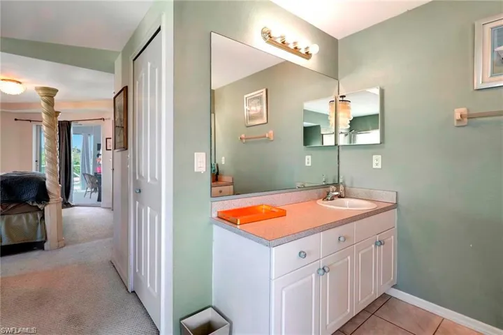 Ensuite bathroom with vanity and baseboards