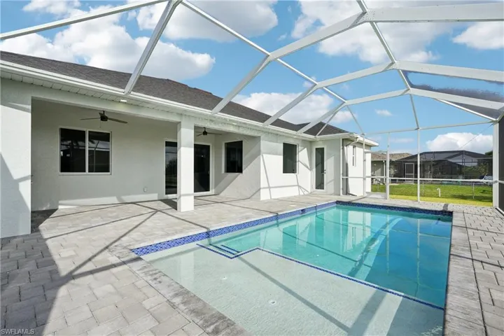 Pool with a ceiling fan, a lanai, and a patio area