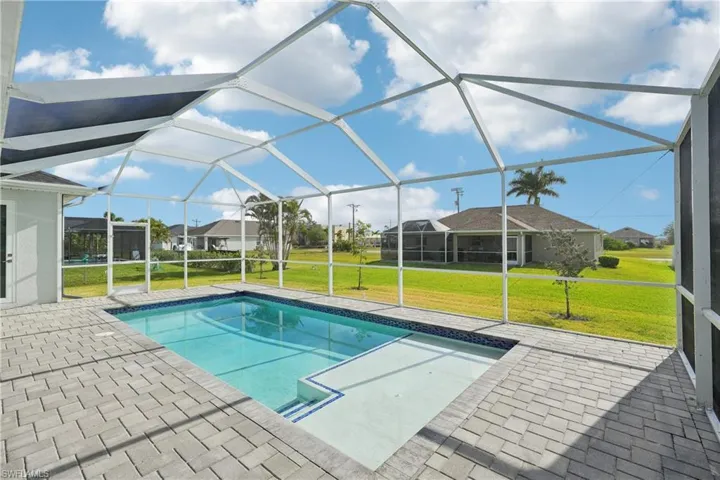 Pool featuring a lanai, a patio area, and a yard