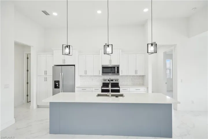Kitchen with tasteful backsplash, stainless steel appliances, marble finish floor, a sink, and visible vents