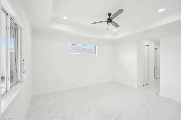 Spare room featuring marble finish floor and recessed lighting