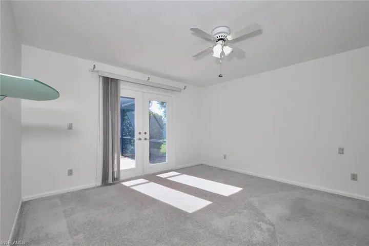 The owners suite has newer carpet and French Doors.  Imagine a fresh coat of paint to your liking, photos, furniture - very very nice room! Plenty of room for a king size bed!