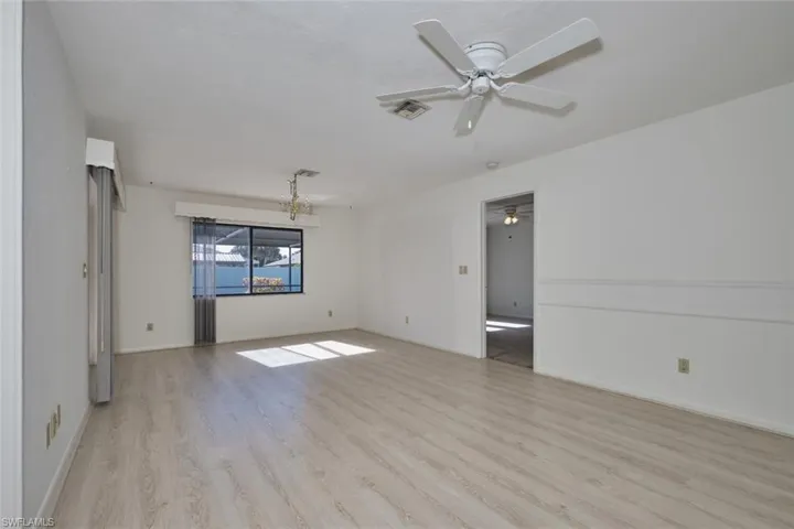 Family Room/Combination dining area.  New flooring makes this room bright and sunny with the Southern exposure!  The doorway to the right leads to the owner's suite.