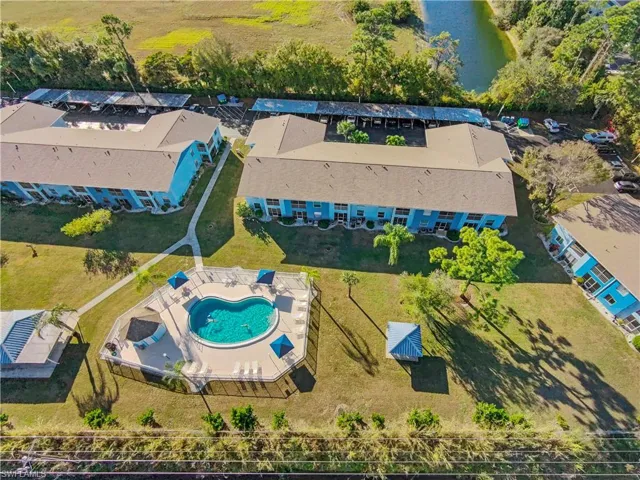 Aerial view of a pool and a large body of water