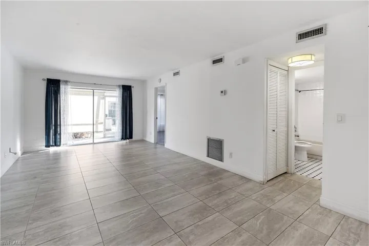 Unfurnished room featuring light tile patterned floors and baseboards