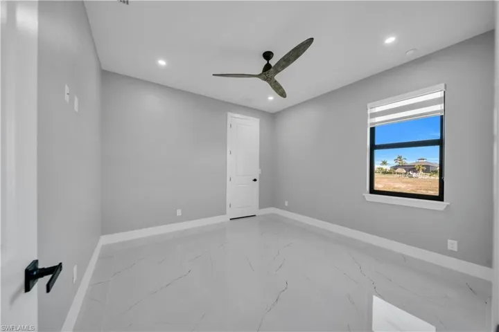 Spare room with light marble finish flooring, recessed lighting, and a ceiling fan