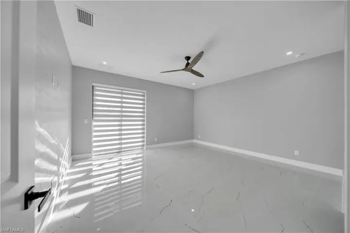 Spare room featuring light marble finish floors, a ceiling fan, and recessed lighting