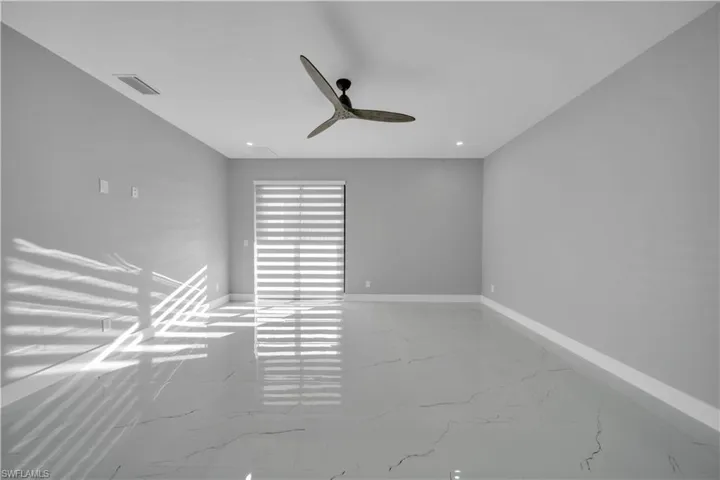 Spare room with light marble finish flooring, recessed lighting, and ceiling fan