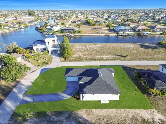 Aerial perspective of suburban area with a nearby body of water