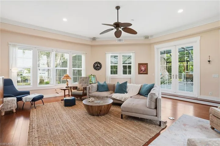 Living area featuring hardwood / wood-style flooring, ceiling fan, french doors, baseboard heating, and recessed lighting