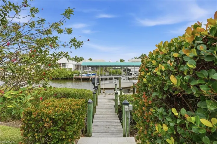 Dock area featuring a water view and boat lift