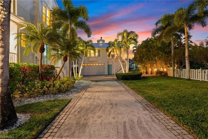 View of front of home with decorative driveway and an attached garage