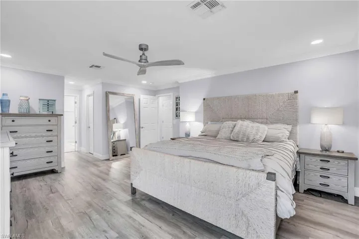 Bedroom with ceiling fan, crown molding, and tons of natural light
