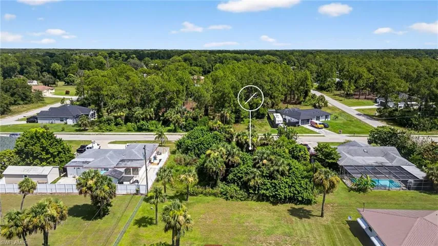 Aerial perspective of suburban area with a forest