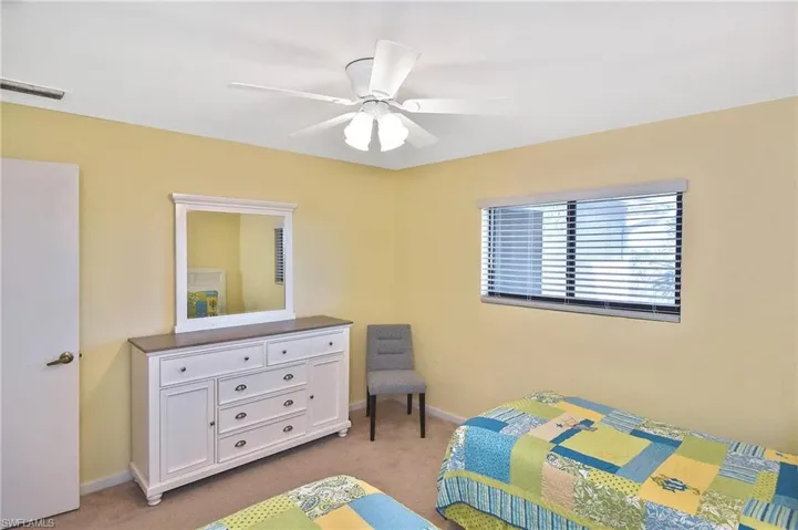 Bedroom featuring light colored carpet and a ceiling fan
